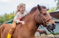 happy little girl riding pony horse bareback and laugh Royalty Free Stock Photo