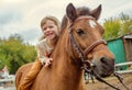 happy little girl riding pony horse bareback and laugh Royalty Free Stock Photo