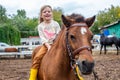 happy little girl riding pony horse bareback and laugh Royalty Free Stock Photo