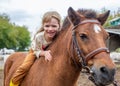happy little girl riding pony horse bareback and laugh Royalty Free Stock Photo