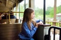 Happy little girl riding a train in a theme park or funfair Royalty Free Stock Photo