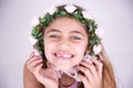 Happy little girl with roses around the face Royalty Free Stock Photo