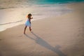 Happy little girl run and play at sunset beach Royalty Free Stock Photo
