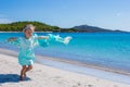 Happy little girl running along the beach with Royalty Free Stock Photo