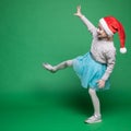 Happy little girl in Santa Claus hat jumping Royalty Free Stock Photo