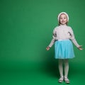Happy little girl in Santa Claus hat jumping Royalty Free Stock Photo