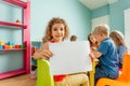 Happy little girl showing her drawing to the camera Royalty Free Stock Photo