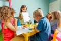 Happy little girl showing her drawing to the camera Royalty Free Stock Photo