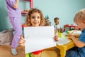 Happy little girl showing her drawing to the camera Royalty Free Stock Photo