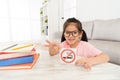 Happy little girl showing quit smoking symbol sign