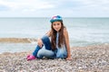 Happy little girl sitting on the beach Royalty Free Stock Photo