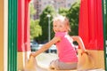 Happy little girl on slide at children playground Royalty Free Stock Photo