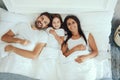 Merry family of parents and their daughter staying in bed Royalty Free Stock Photo