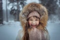 Happy little girl in snowy forest