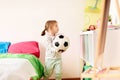 Happy little girl with socker ball at home Royalty Free Stock Photo