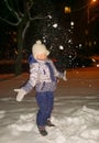 happy little girl standing on city street in winter evening. Royalty Free Stock Photo