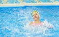 Happy little girl swimming in the pool. Caucasian child is playing fun in the kindergarten pool Royalty Free Stock Photo