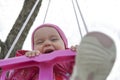 Happy little girl in a swing