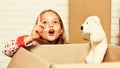 Happy little girl with toy. purchase of new habitation. Cardboard boxes - moving to new house. happy child cardboard box Royalty Free Stock Photo