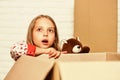 Happy little girl with toy. repair of room. new apartment. Cardboard boxes - moving to new house. purchase of new Royalty Free Stock Photo