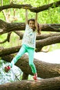 Happy Little Girl on tree trunk