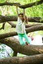 Happy Little Girl on tree trunk