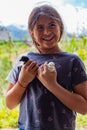 happy little girl with two small chicks outdoor portrait of a little girl school age holding baby chicks and smiling Royalty Free Stock Photo