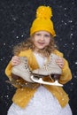 Happy little girl under the white snow holds skates Royalty Free Stock Photo