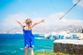 Happy little girl with view on Little Venice the most popular tourist area on Mykonos island, Greece. Royalty Free Stock Photo