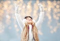 Happy little girl wearing earmuffs over lights Royalty Free Stock Photo