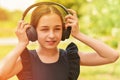 Happy little girl wearing headphones. Stereo sound. Headphones with wireless technology