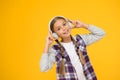 Happy little girl wearing modern headphones. Cute kid enjoying stereo sound. Wireless means freedom. Headphones with