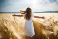 happy little girl in white dress run in wheat field