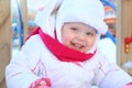 Happy little girl in white plays on playground Royalty Free Stock Photo