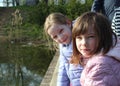 Happy little girlfriends in park