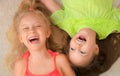 Happy little girls lying on their back. Top view Royalty Free Stock Photo