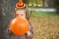 Happy girls blowing balloon for Halloween party