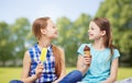 Happy little girls eating ice-cream in summer park Royalty Free Stock Photo