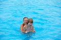 Happy little girls have fun swimming in the pool. Wonderful mood Royalty Free Stock Photo