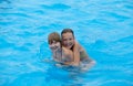 Happy little girls have fun swimming in the pool. Wonderful mood Royalty Free Stock Photo