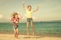 Happy little girls jumping on beach Royalty Free Stock Photo