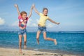 Happy little girls jumping on beach Royalty Free Stock Photo