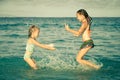 Happy little girls playing at the beach Royalty Free Stock Photo