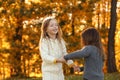 Happy little girls playing in park. Autumn walk Royalty Free Stock Photo