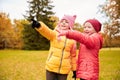 Happy little girls pointing finger in autumn park Royalty Free Stock Photo