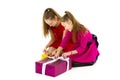 Cheerful little girls enjoy gifts. Family holidays concept.