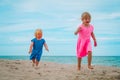 Happy little girls run and have fun on tropical beach Royalty Free Stock Photo