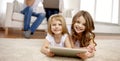 Happy little girls with tablet pc computer at home Royalty Free Stock Photo