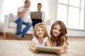 Happy little girls with tablet pc computer at home Royalty Free Stock Photo