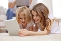 Happy little girls with tablet pc computer at home Royalty Free Stock Photo